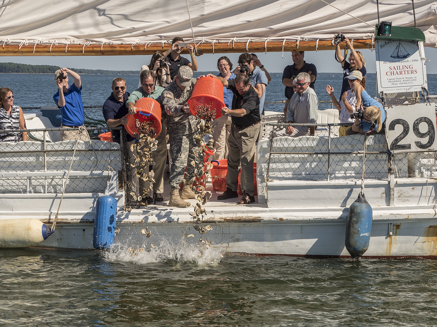 The last bushels of shell are dumped onto the Harris Creek Oyster Sanctuary in a ceremony in 2015.